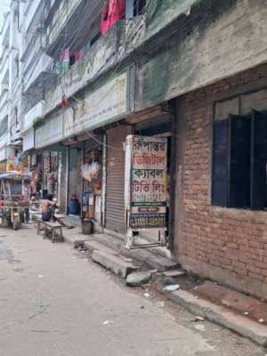 The gate behind the banner is a business shop