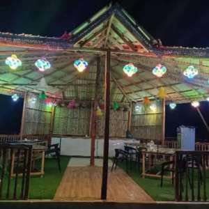 Open-air dining restaurant and fresh seafood BBQ lounge illuminated at night