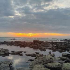 Mesmerizing sunset view over coastal coral rocks on the quiet southern beach